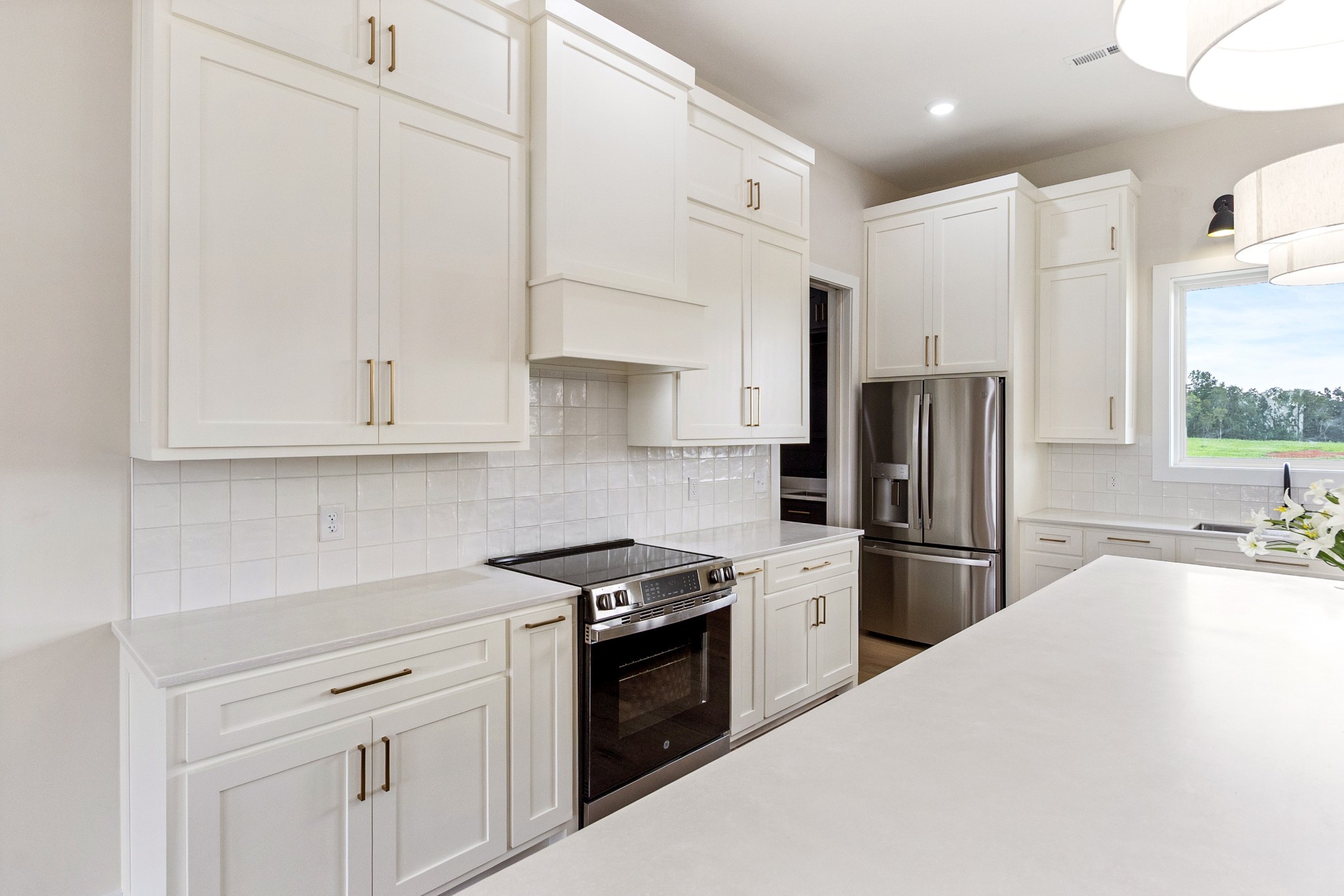 188 Beartown Road Loretto, TN 38469 - Photo 10 of 33 a kitchen with stainless steel appliances a refrigerator stove and white cabinets