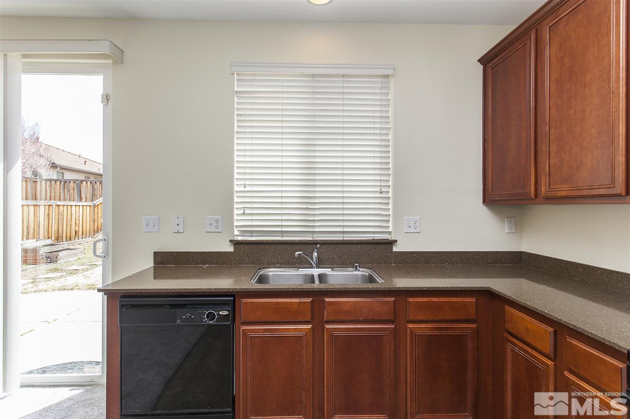 380 Terracina Way Reno, NV 89521 - Photo 9 of 25 a kitchen with granite countertop cabinets sink and window
