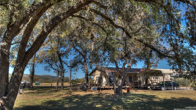 a front view of a building with trees