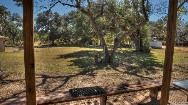a view of a yard with wooden fence