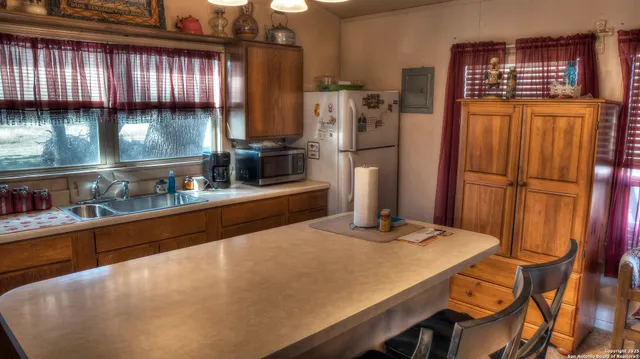 a kitchen with refrigerator and window
