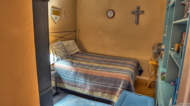 a bedroom with a bed and a mirror