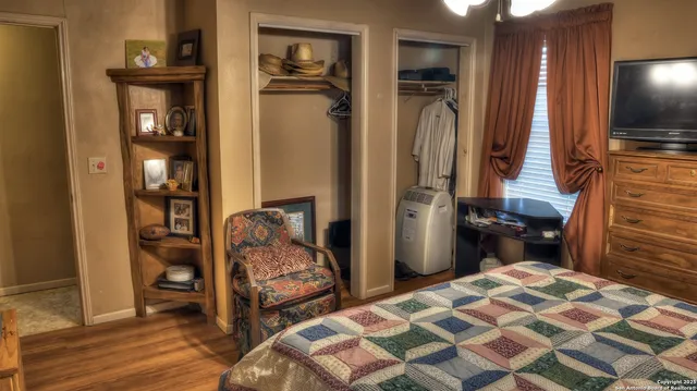 a bedroom with a bed and a mirror