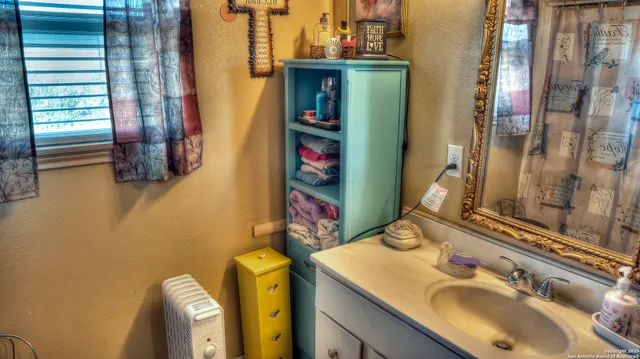 a bathroom with a sink vanity and a mirror