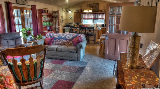 a living room with furniture a lamp and a potted plant