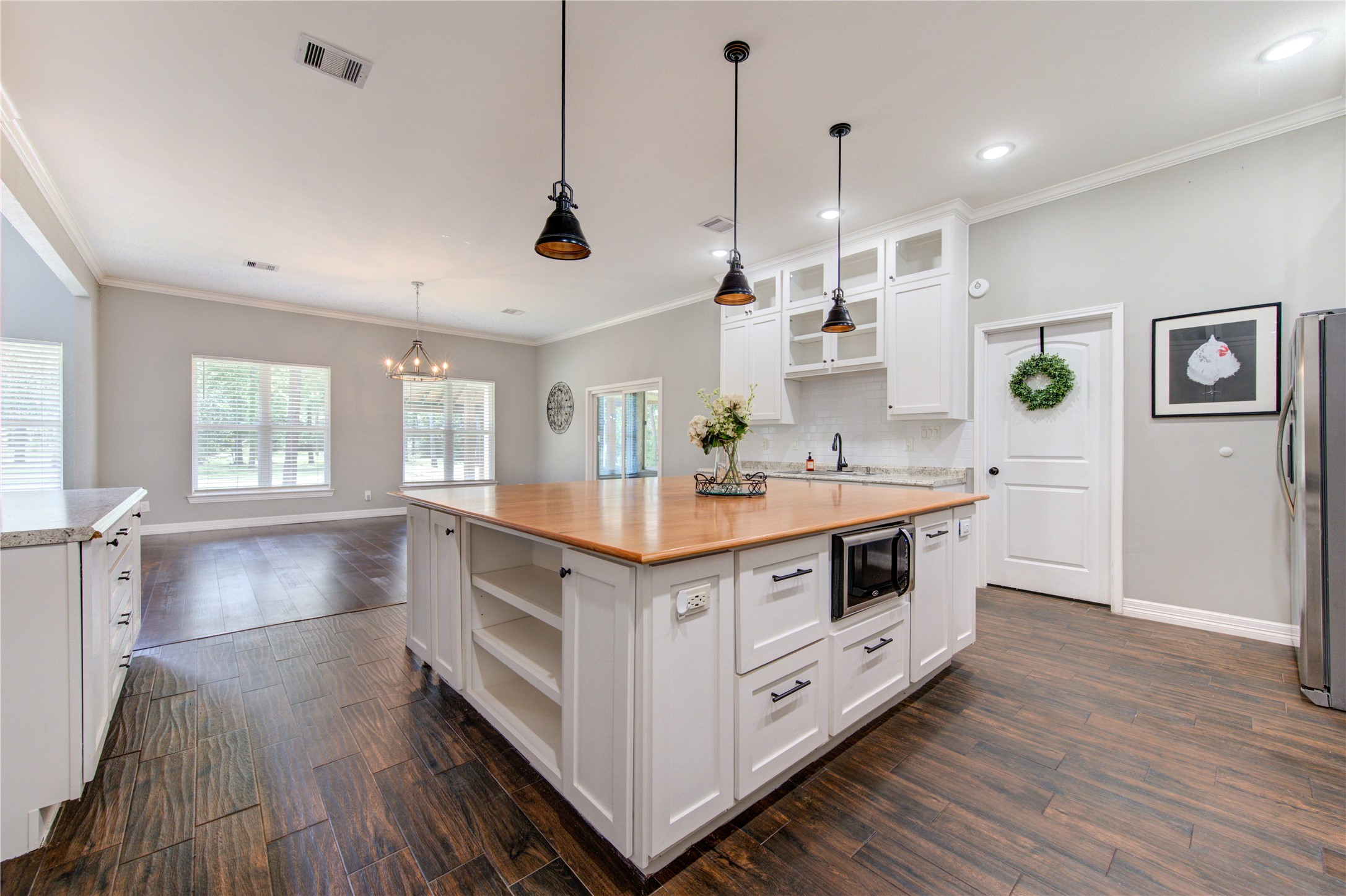 20531 Faye Tomball, TX 77377 - Photo 16 of 43 a kitchen with stainless steel appliances a stove and white cabinets with wooden floor