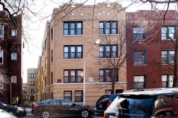 a couple of cars parked in front of a building