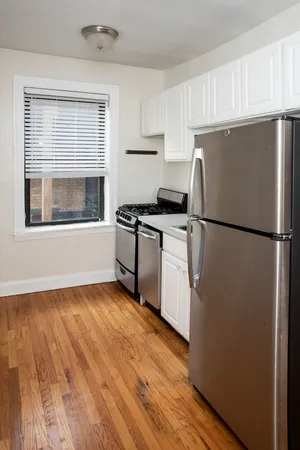 a kitchen with wooden floors and white appliances