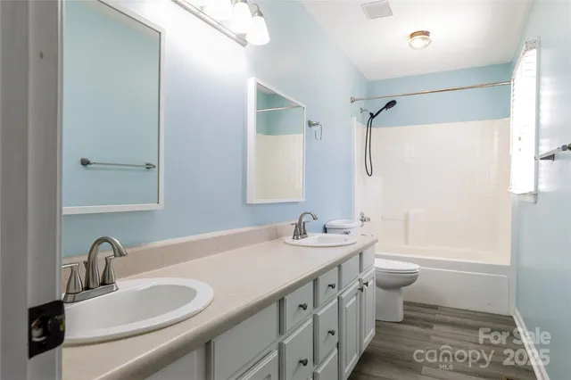 a bathroom with a double vanity sink mirror double vanity and bathtub