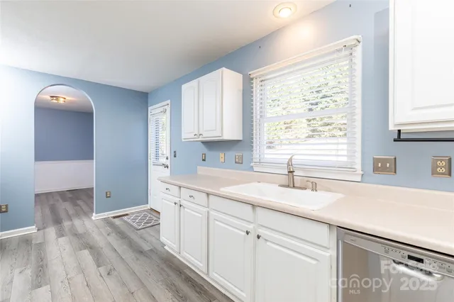 a kitchen with a sink cabinets and window