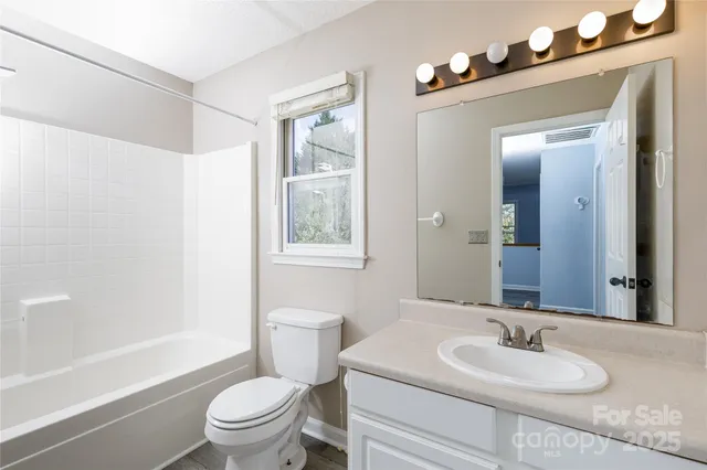 a view of an empty room with a fireplace and a window