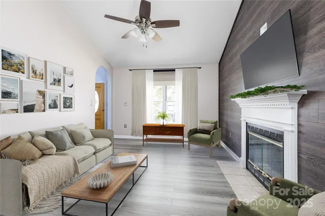 a living room with furniture and a fireplace