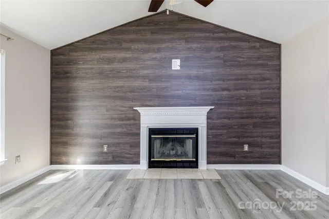 a view of an empty room and fire place