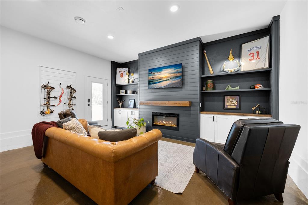 24825 Northwest 201st Road High Springs, FL 32643 - Photo 16 of 31 a living room with furniture and a flat screen tv