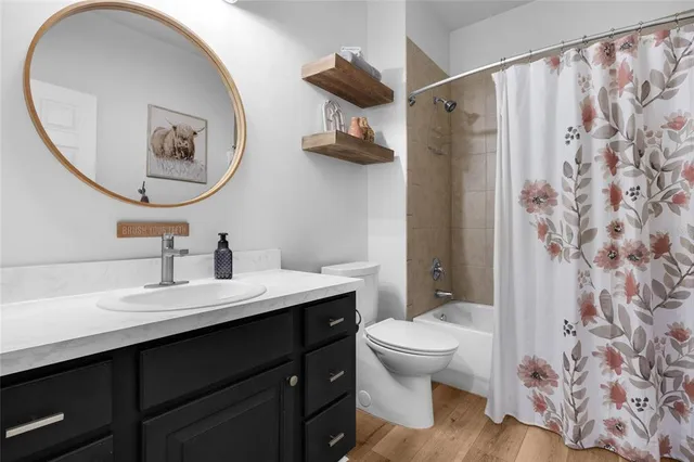 a bathroom with a toilet a sink and a mirror