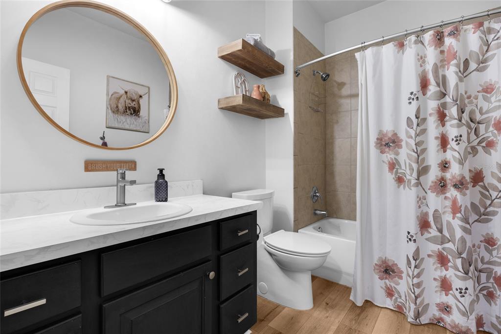 24825 Northwest 201st Road High Springs, FL 32643 - Photo 23 of 31 a bathroom with a toilet a sink and a mirror