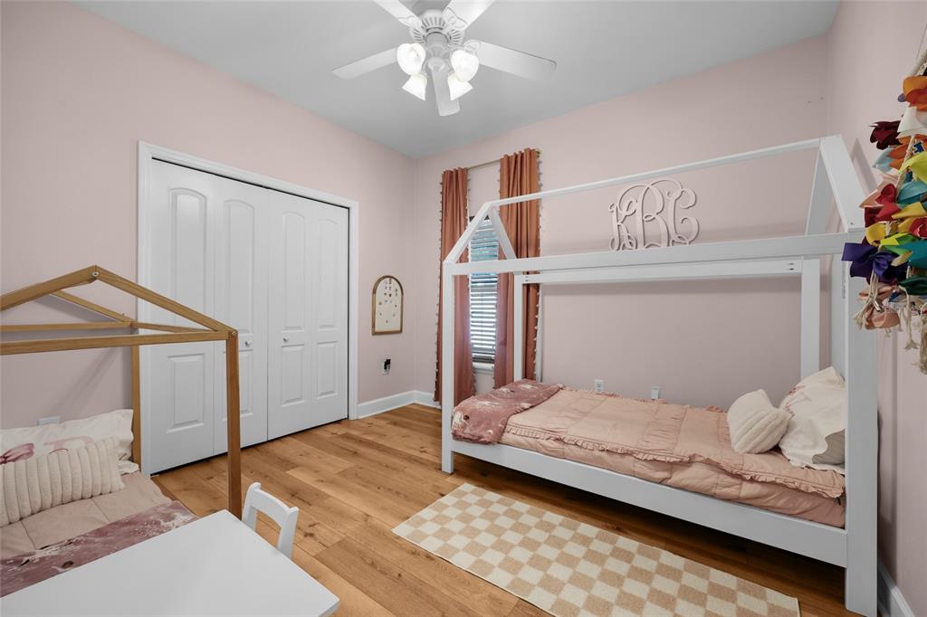 24825 Northwest 201st Road High Springs, FL 32643 - Photo 25 of 31 a bedroom with a bed and a chandelier