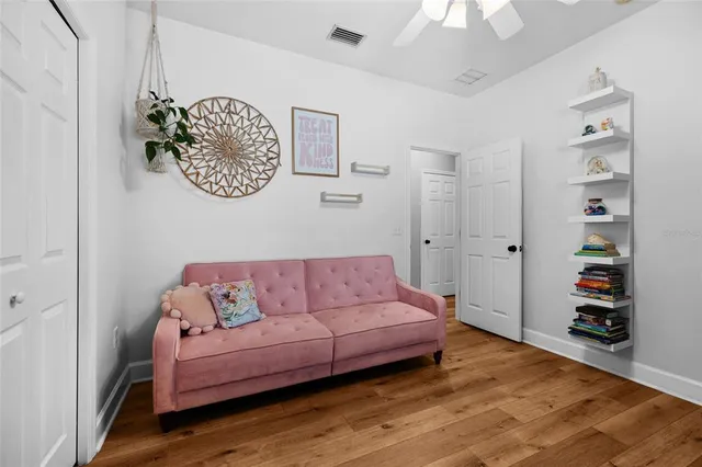 a living room with furniture and a book shelf