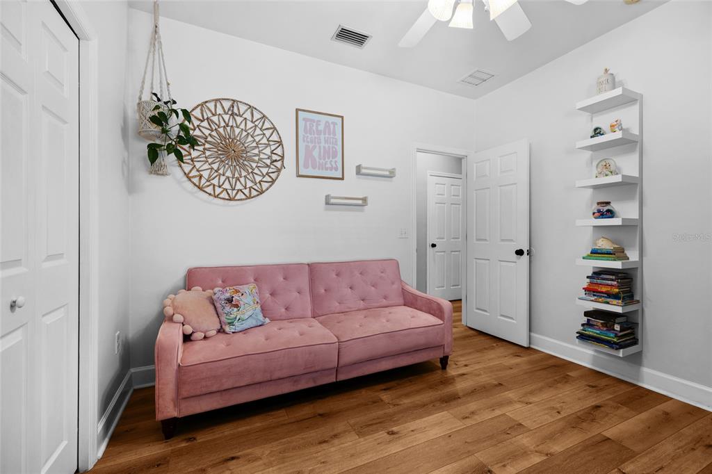 24825 Northwest 201st Road High Springs, FL 32643 - Photo 28 of 31 a living room with furniture and a book shelf