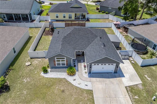 an aerial view of multiple houses with a yard