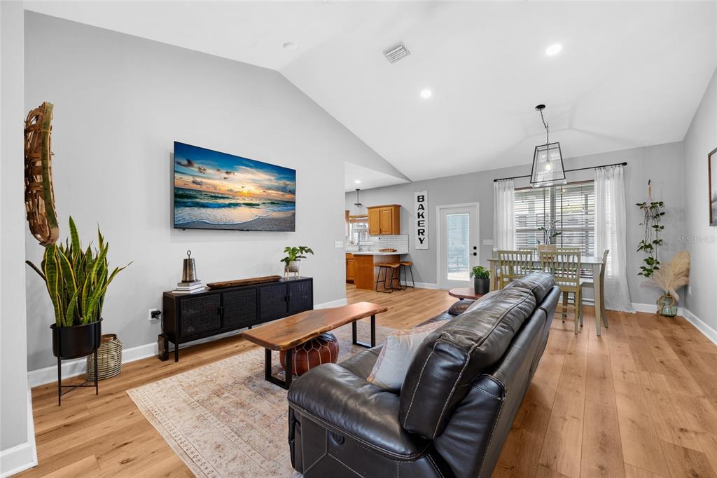 24825 Northwest 201st Road High Springs, FL 32643 - Photo 7 of 31 a living room with furniture a chandelier and a flat screen tv