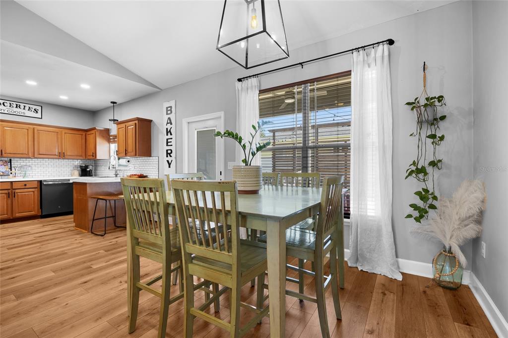 24825 Northwest 201st Road High Springs, FL 32643 - Photo 10 of 31 a dining room with furniture potted plants and wooden floor