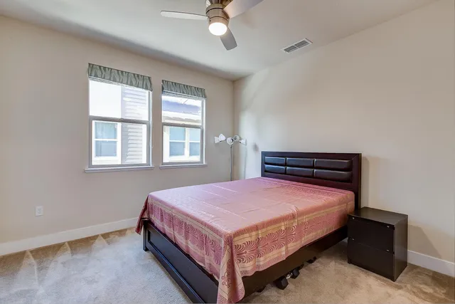 a bathroom with a granite countertop sink toilet a large mirror a bathtub and shower