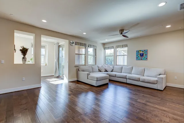 a living room with furniture and a wooden floor