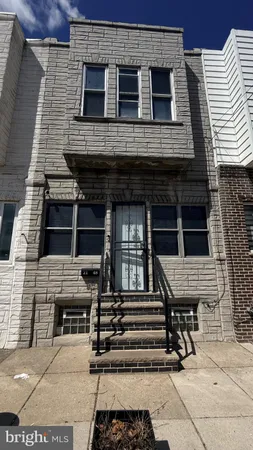 a front view of a house with stairs