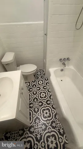 a bathroom with a bathtub and a toilet