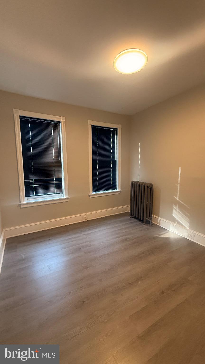 2148 South Lambert Street Philadelphia, PA 19145 - Photo 14 of 19 a view of an empty room with window and wooden floor