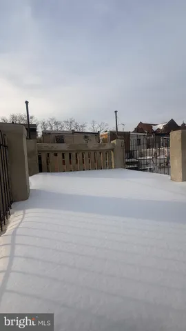 a view of a terrace with tall buildings