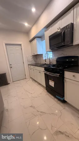 a kitchen with stainless steel appliances granite countertop a stove and a sink