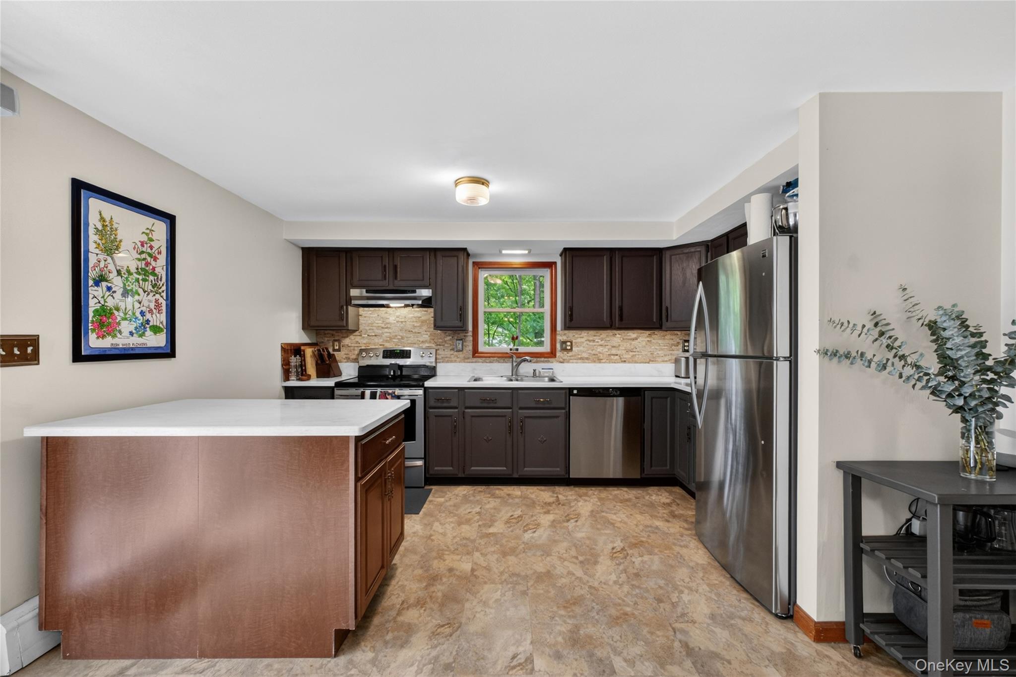127 Belvedere Road Beacon, NY 12508 - Photo 9 of 37 a kitchen with stainless steel appliances granite countertop a refrigerator a sink dishwasher a stove with wooden cabinets and floor