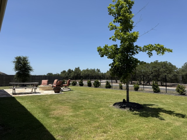 170 Climbing Rock Loop Dripping Springs, TX 78620 - Photo 27 of 30 A spacious lawn provides ample room for recreation, anchored by a fire pit lounge area.