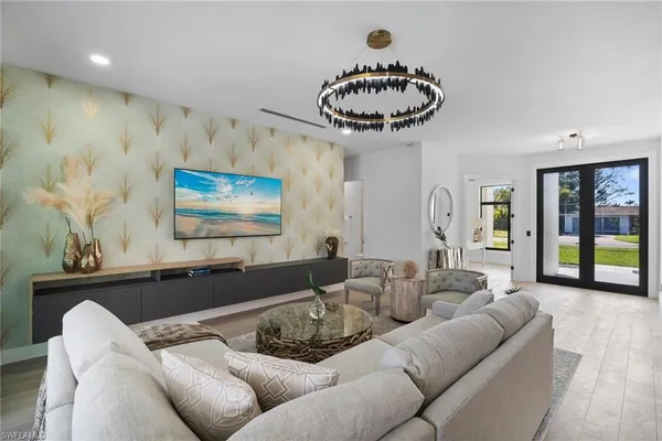 a living room with furniture and kitchen view