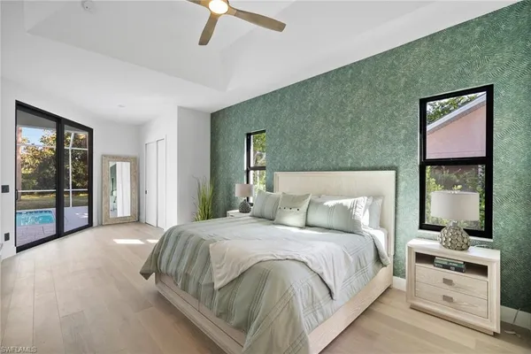 a spacious bedroom with a bed and a chandelier