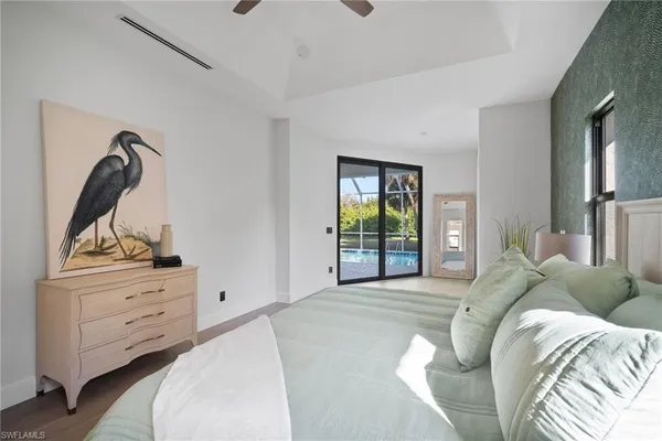 a bed room with a bed and a mirror