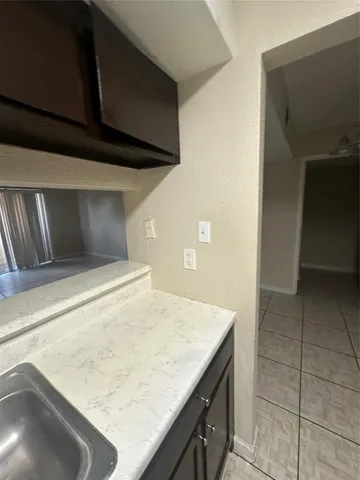 a kitchen with a sink and cabinets