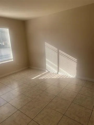 an empty room with a empty space and a window