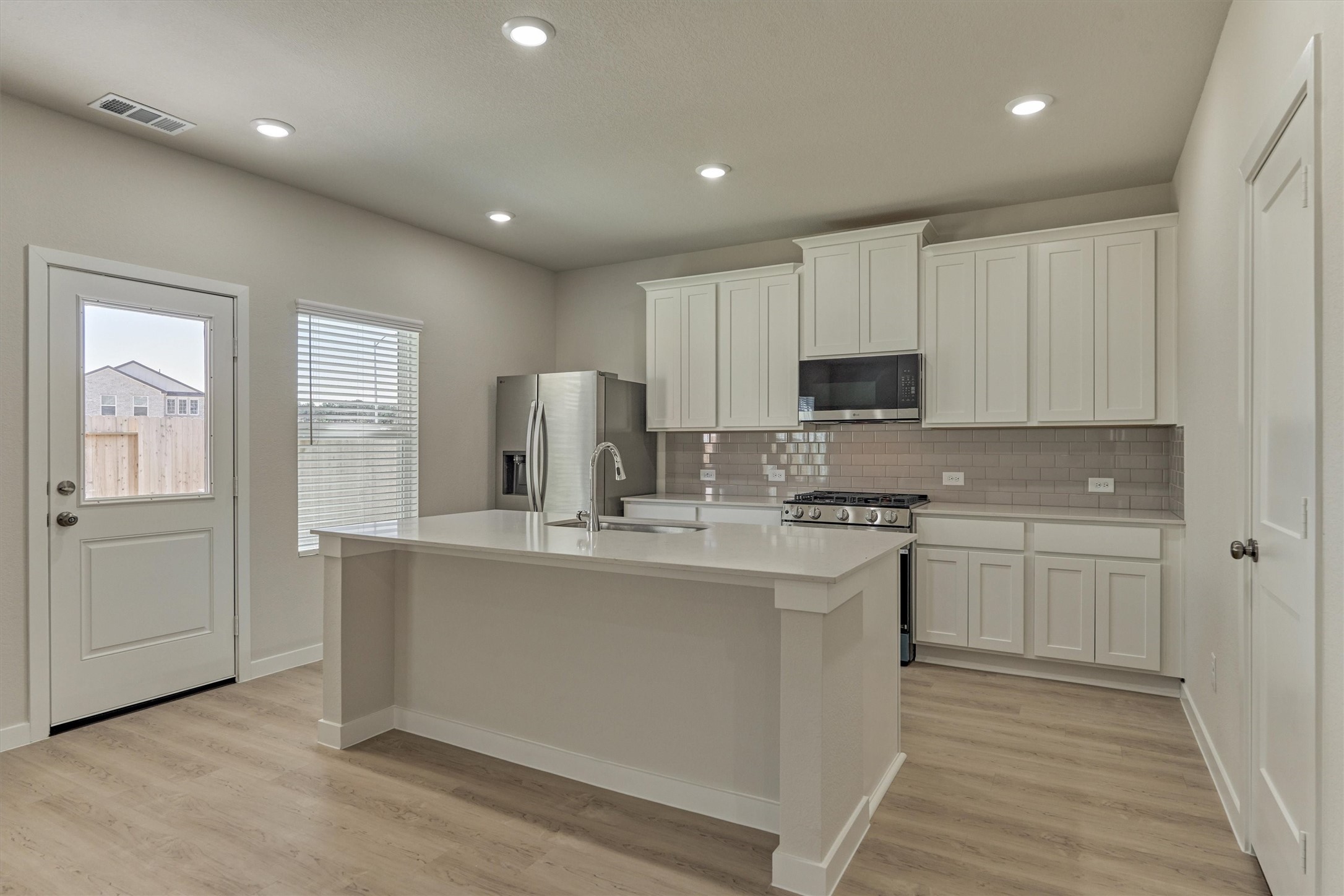 282 Brazen Forest Trail Magnolia, TX 77355 - Photo 13 of 36 a kitchen with stainless steel appliances granite countertop a stove a sink and a refrigerator