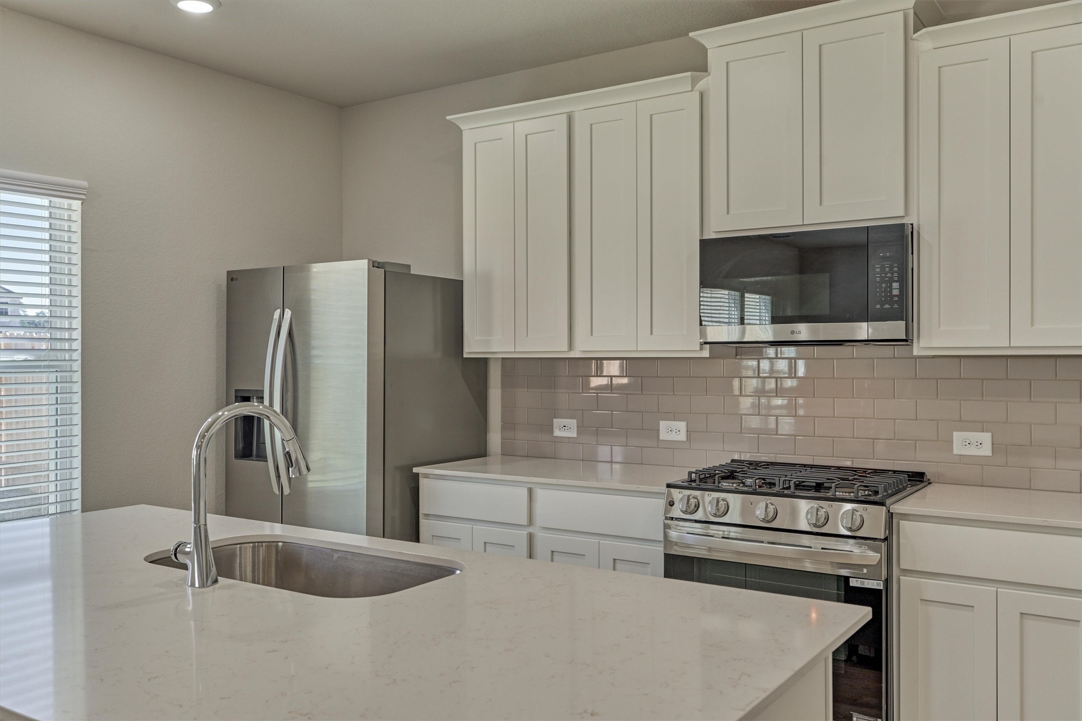 282 Brazen Forest Trail Magnolia, TX 77355 - Photo 15 of 36 a kitchen with stainless steel appliances a refrigerator stove and microwave