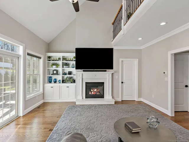 a living room with furniture a fireplace and a flat screen tv