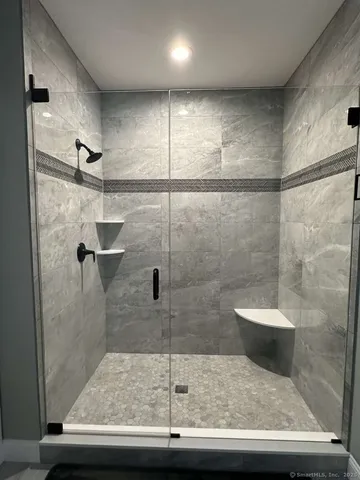 a bathroom with a granite countertop shower