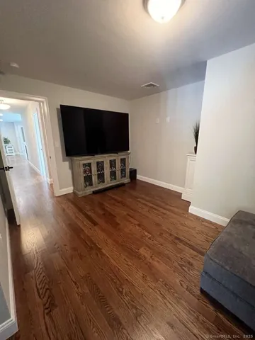 a living room with a flat screen tv and a couch