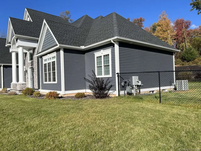 a view of a house with a yard and sitting area