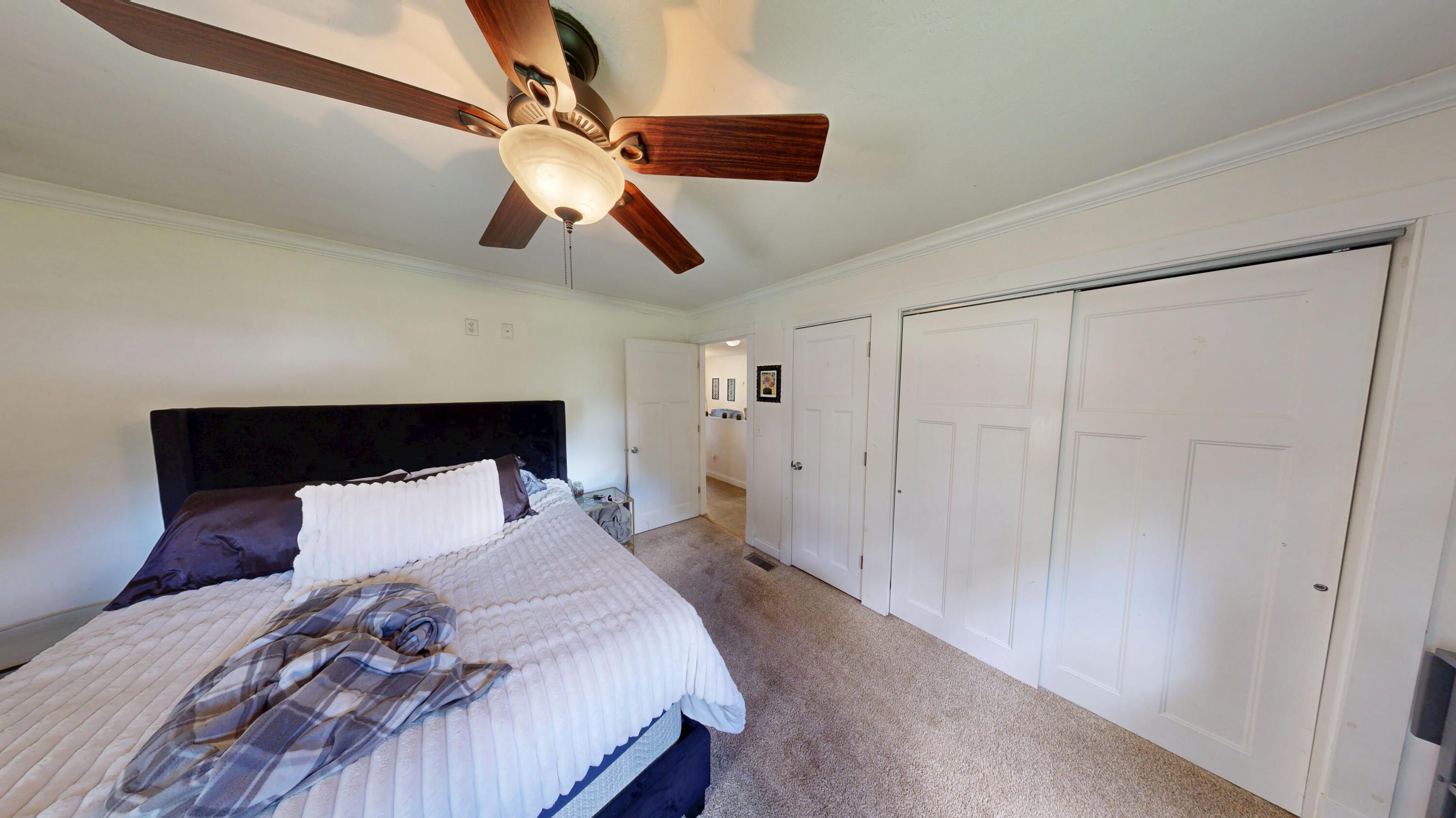 4305 Colfax Street Gary, IN 46408 - Photo 11 of 27 a bedroom with a bed and a chandelier