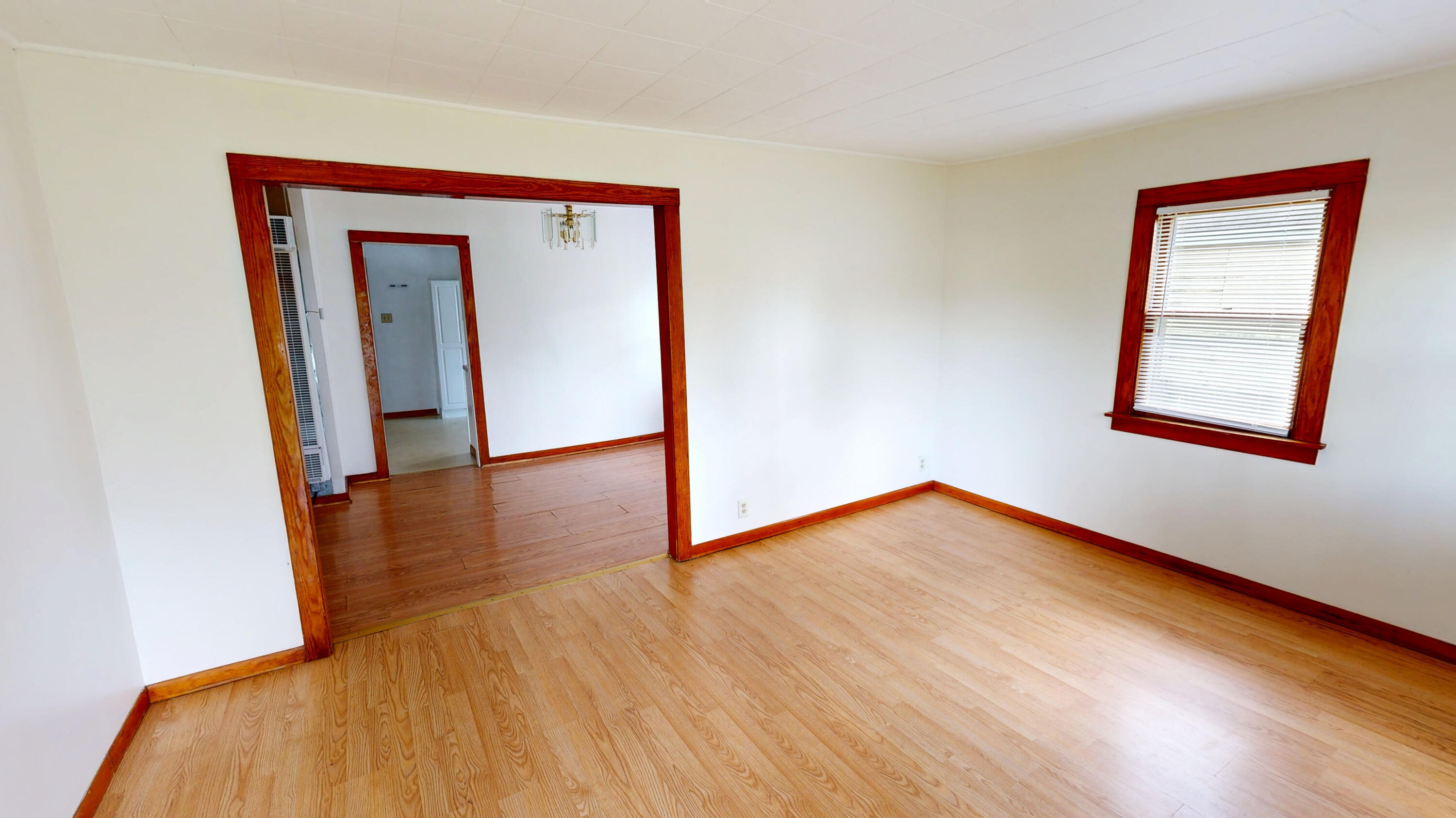 4305 Colfax Street Gary, IN 46408 - Photo 19 of 27 a view of an empty room with wooden floor and a window