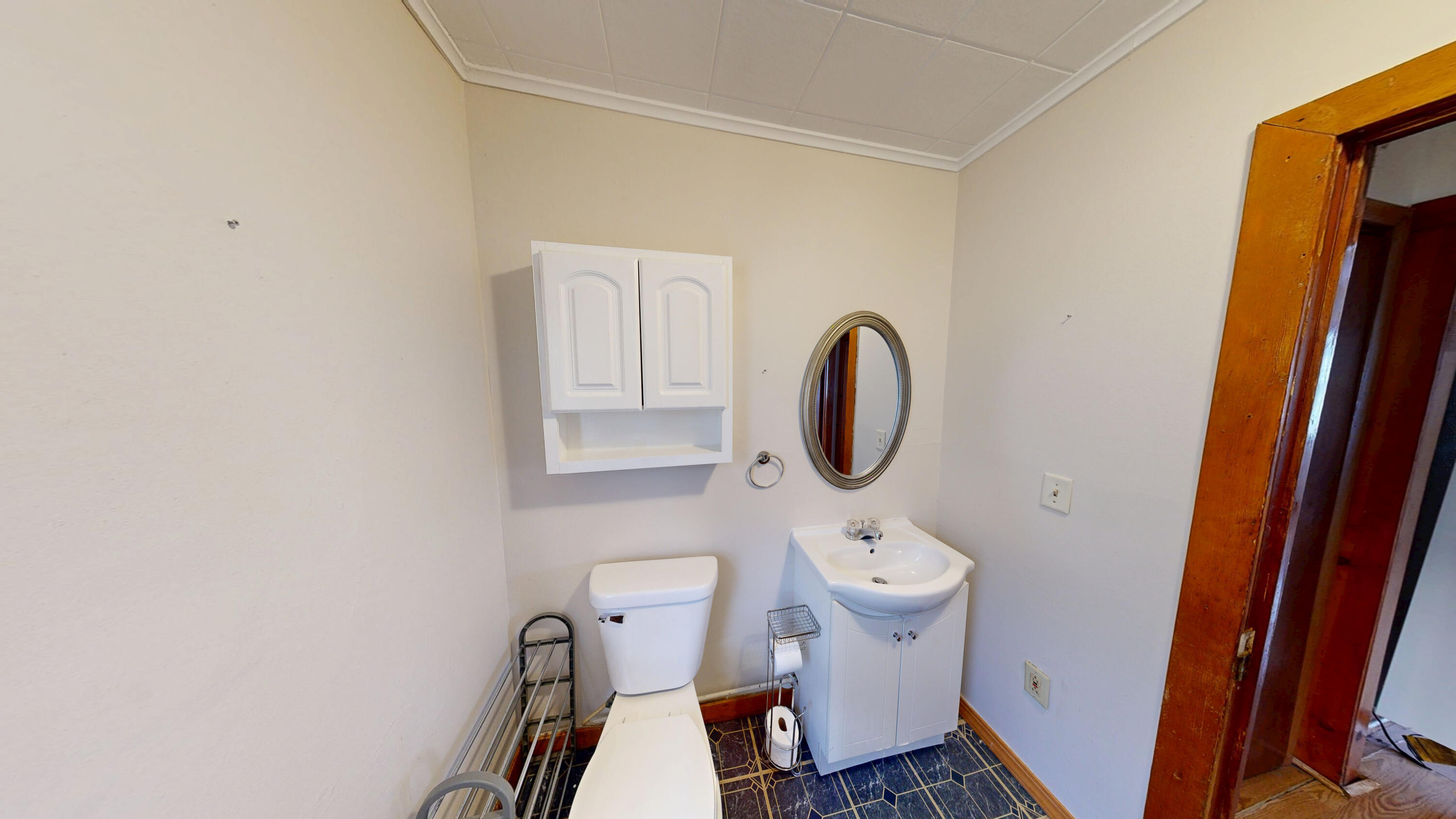 4305 Colfax Street Gary, IN 46408 - Photo 23 of 27 a bathroom with a toilet a sink and a mirror