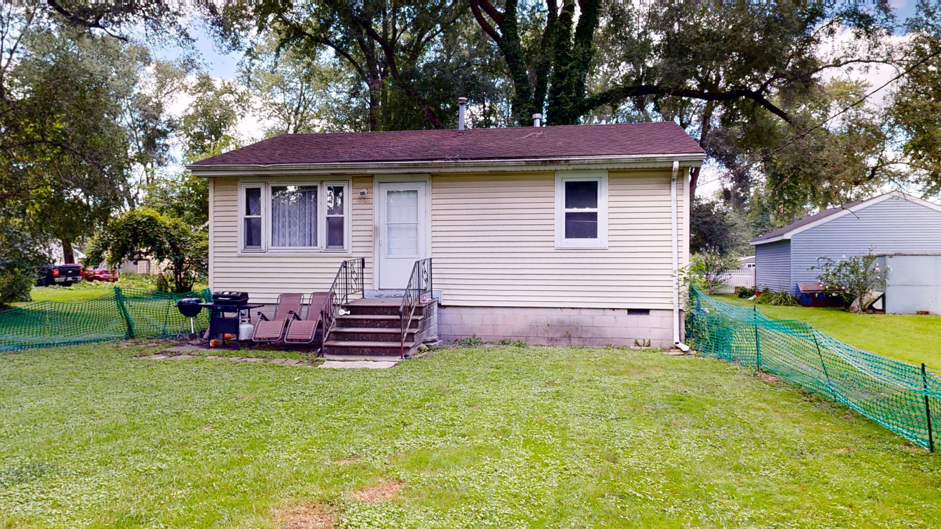 4305 Colfax Street Gary, IN 46408 - Photo 3 of 27 a front view of a house with a garden and deck